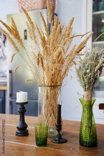 Decorative dried flowers and candles in home setting