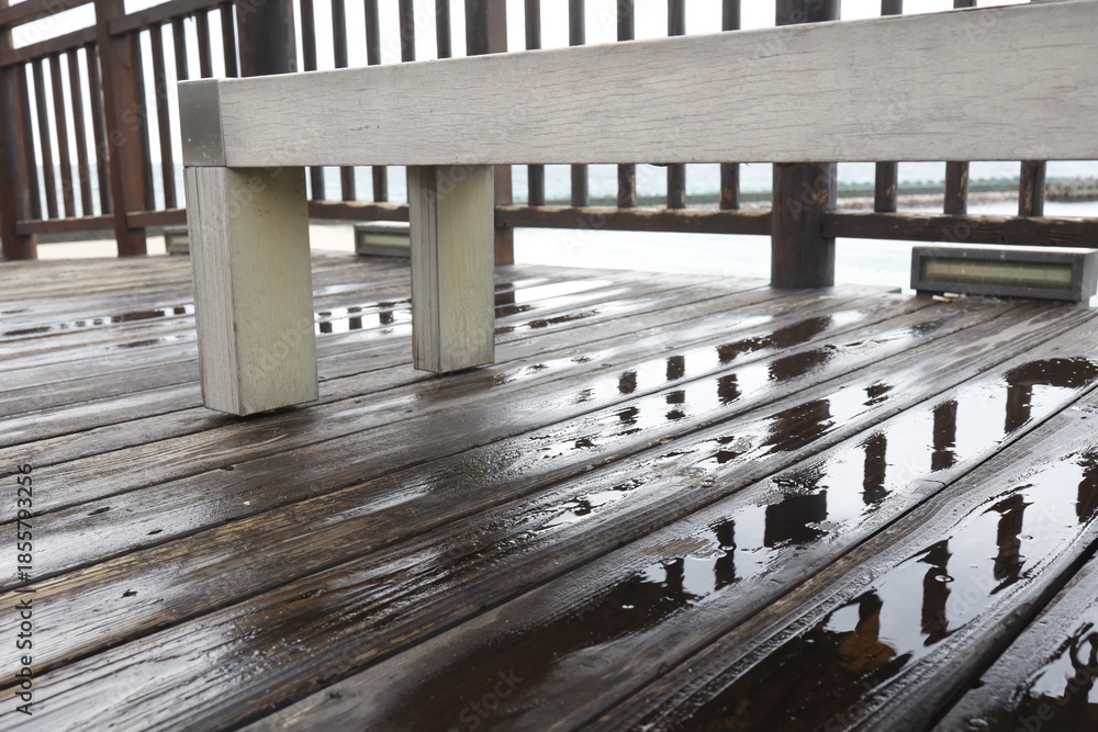 Obraz premium 雨で濡れた屋外ウッドデッキ。濡れた木材イメージ。