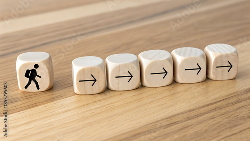 Conceptual image of a single walking person icon on a cube moving in a line with other arrow cubes