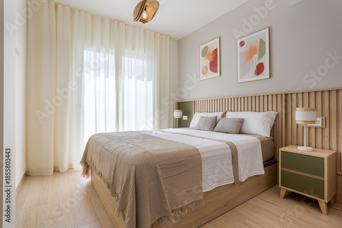Bright minimalist bedroom with wood accents, cozy bed and modern wall art decor