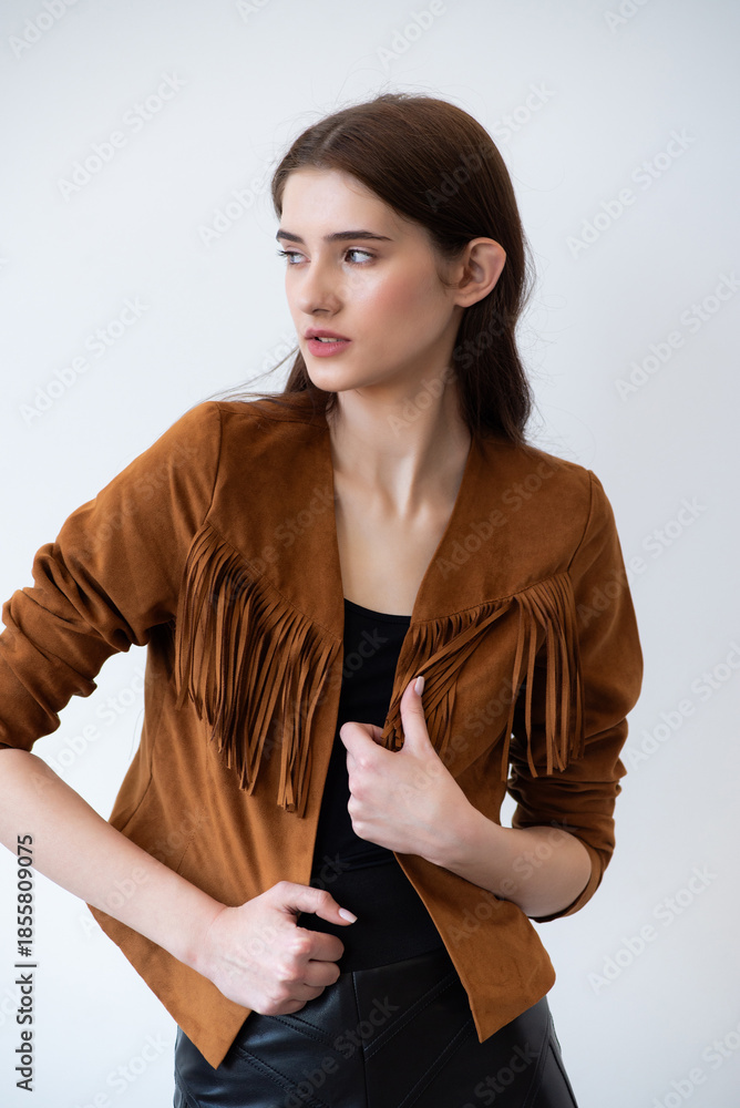 Obraz premium Beautiful fashion model in beige trench coat posing confidently in studio, professional female portrait for model agency portfolio, minimal clean background modern fashion concept