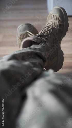 A soldier in pixelated uniform is resting during his vacation.