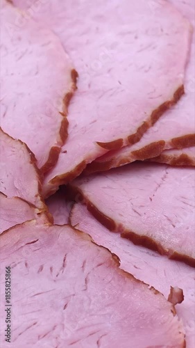 Sliced pork ham texture close-up. Food background, vertical video
