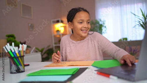 Young african american girl learning online at home