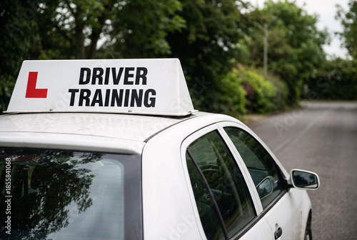 Driving school learner car with driver training sign on roof, road safety education and new driver lessons concept.