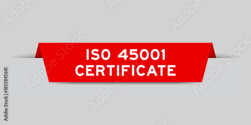 Red color inserted label with word ISO 45001 certificate on gray background
