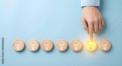 hand choosing different idea, glowing light bulb, inspiration concept