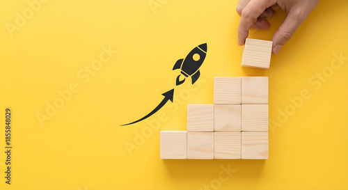 Business growth concept with wooden blocks and rocket