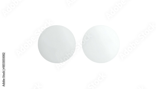 Two white, circular objects with dark outlines floating against a black background