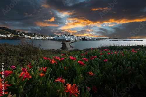 Dusk paints Naxos Town as warm lights shimmer above winding streets.