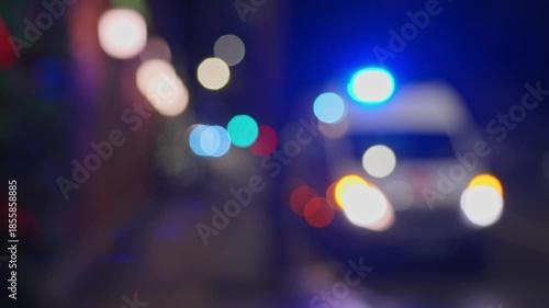 4k, A panoramic blurred view of an ambulance parked at the pavement with blue warning lights on, at nighttime, Saint Petersburg, Russia