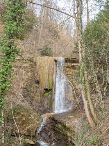 Pfannenstil, Switzerland - March 9th 2025: Idyllic waterfall in Bachtobel ravine close to Meilen.