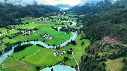 Experience the breathtaking beauty of Stryn, Norway, with its verdant fields and meandering rivers.