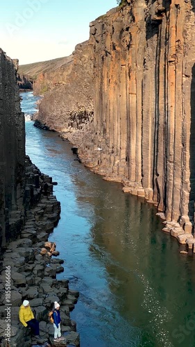 Discover the stunning beauty of Studlagil Canyon in Iceland, featuring towering basalt columns and a tranquil river. This unique location offers perfect opportunities for exploration and photography.