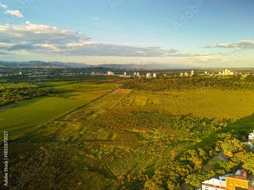 aerial view of a sunset near Banhado in Sao Jose dos Campos with astonishing colors and the city in the background.