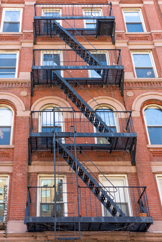 A classic red brick apartment building facade in New York City.