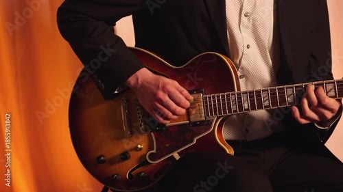 Male Band Member Playing An Electric Guitar On Stage. Close-up Shot