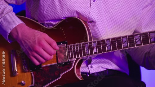Person's Hands Playing Electric Guitar In The Studio. - closeup shot
