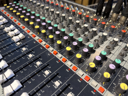 Sliders and volume knobs on DJ control panel. Concept of music control at event. Professional sound designer control panel. Adjusting sound and volume. Multicolored volume controls