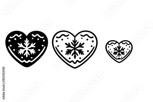 Three heart-shaped gingerbread cookies with snowflake decorations