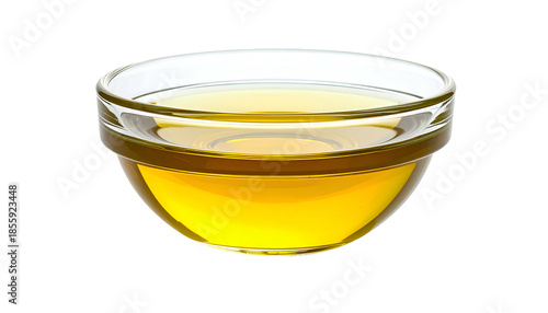 A clear glass bowl filled with golden-yellow, shimmering liquid, on a solid black background