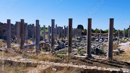 SIDE, TURKEY, June 16, 2024: Ruins of the ancient city of Side in Antalya province on the Mediterranean coast. Amazing ruins of an ancient city. Old statues in the State Agora.The ancient city wall.4K