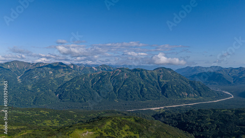 Mountainous landscape with lush greenery under clear blue sky