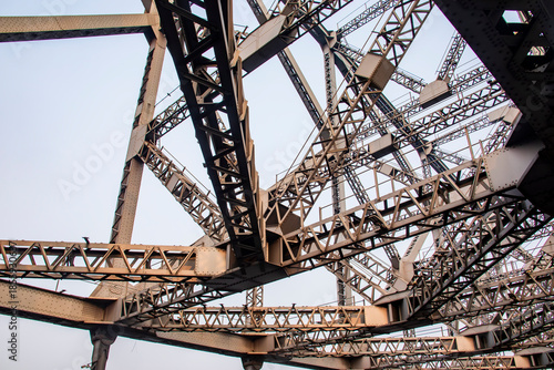 Howrah Bridge spans the Hooghly River in Kolkata India, an iconic steel cantilever built in 1943, carrying endless traffic and symbolizing the city’s pulse.