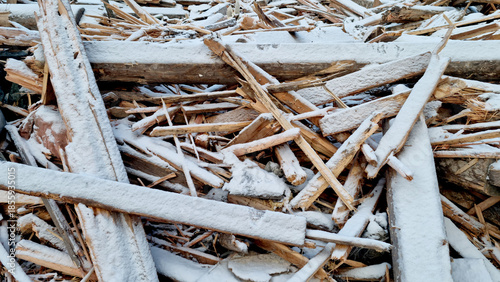 Garbage dump. Close-up of a demolished wooden house in the snow. Winter background. 
Environmental pollution.
