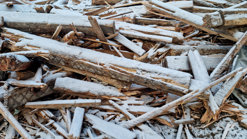 Garbage dump. Close-up of a demolished wooden house in the snow. Winter background. 
Environmental pollution.
