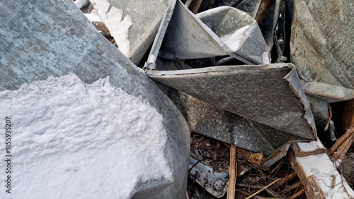 Garbage dump. Close-up of a demolished wooden house in the snow. Winter background. 
Environmental pollution.
