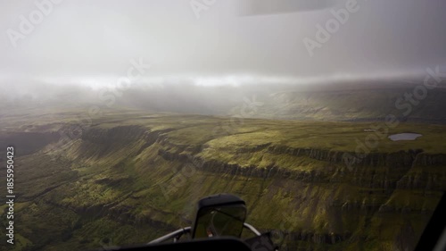 Helicopter Tour Above Steep Cliffs and Plateau in Iceland