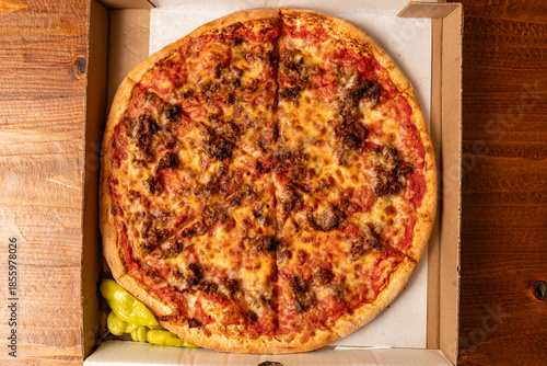 Pizza with sausage and tomatoes