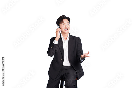 Modern Communicator: A professional in a sharp suit sits, engaged in a vibrant phone conversation, possibly closing a deal or delivering good news.