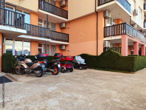photography of motorbikes parked outside a building high quality horizontal image perfect for campaigns
