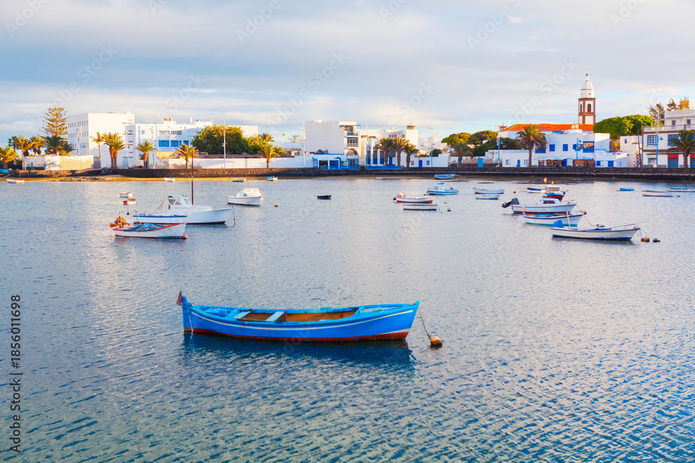 Fototapeta premium Charco de San Gines, lagoon and urban harbor in Arrecife, capital of Lanzarote in Canary Islands, Spain. Scenic area whit fishermen cottages and promenade with bars and restaurants, moored small boats