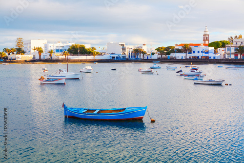 Charco de San Gines, lagoon and urban harbor in Arrecife, capital of Lanzarote in Canary Islands, Spain. Scenic area whit fishermen cottages and promenade with bars and restaurants, moored small boats