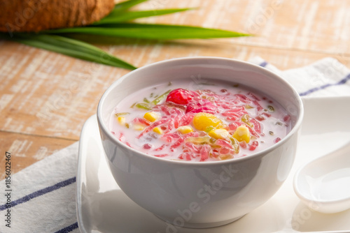 Thai iced dessert (Ruam Mit),Popular Thai Fruit Dessert in Coconut Milk in white bowl.