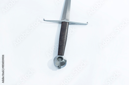 Canvas Print Full-length medieval sword with brown leather wrapped hilt, isolated on white background