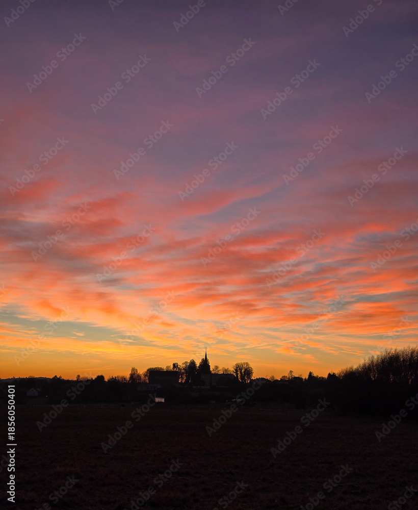 Fototapeta premium sunset over a small village, dramatic sky