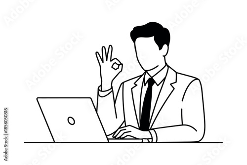 A businessman in a suit and tie sits at a desk with a laptop, giving an okay hand gesture, signifying approval or success.