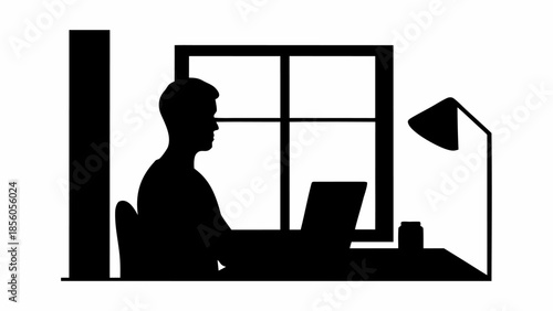 Man working on laptop in modern office space with window