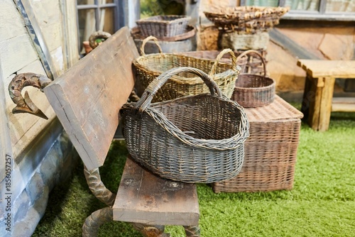 Old wicker baskets are lying on a wooden bench