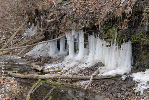 ice formations from water seeping out the side of a hill in winter