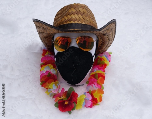 A tropical-themed mannequin head in snowy setting, blending summer vacation vibes with winter chill for humorous visual contrast.
