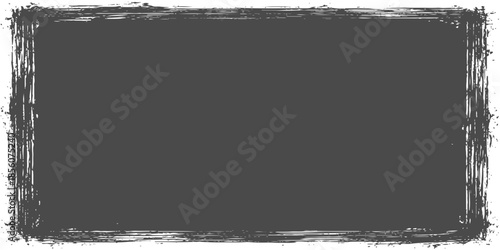 A rough storm wave crashes against the island shore under a cloudy sky within a black and white grunge frame seascape