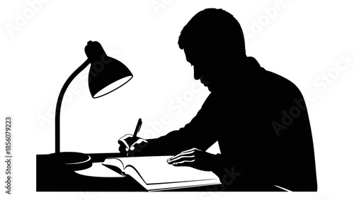 Silhouette of man sitting at desk studying with lamp on
