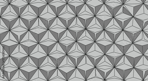 Intricate geometric pattern of grey and white triangular pyramids forming a repetitive three dimensional star structure for modern wallpaper.