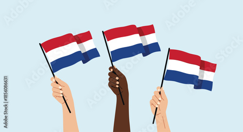 Hands with different skin tones are shown holding and waving flags of the Netherlands, celebrating King's Day or national pride against a blue background.