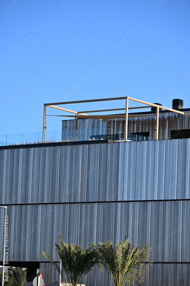 Obraz premium Modern office building with an interesting perforated metal facade